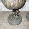 Brocante bronzen olielamp waarvan de voet bewerkt is met een cherubijn